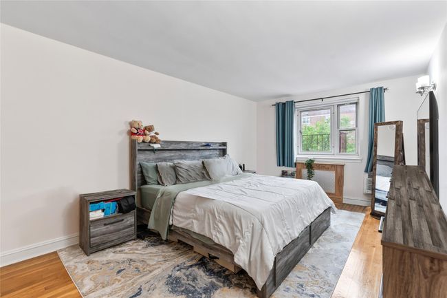 Bedroom with light wood-type flooring and baseboards | Image 10