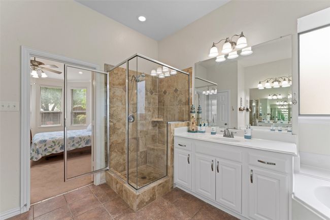 Full bath with vanity, a stall shower, ensuite bath, a ceiling fan, and a garden tub | Image 21