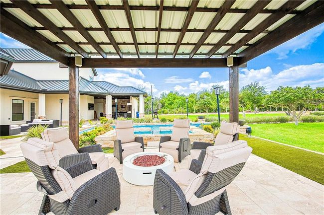 View of patio with an outdoor living space with a fire pit and an outdoor pool | Image 35