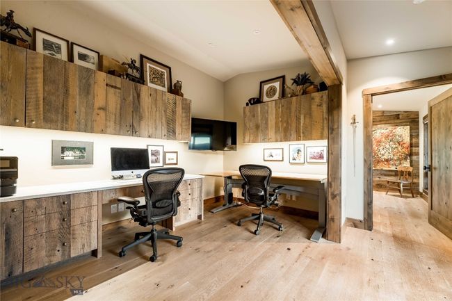 Main level office space with reclaimed wood cabinetry. | Image 27