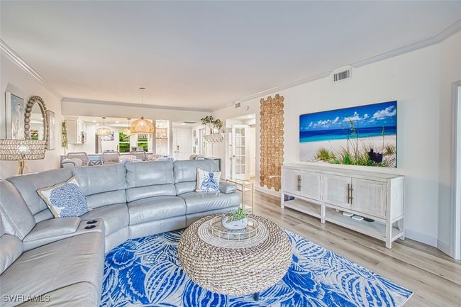 Living room with wood finished floors and crown molding | Image 25
