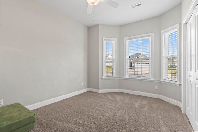 Empty room featuring ceiling fan, visible vents, baseboards, and carpet | Image 21