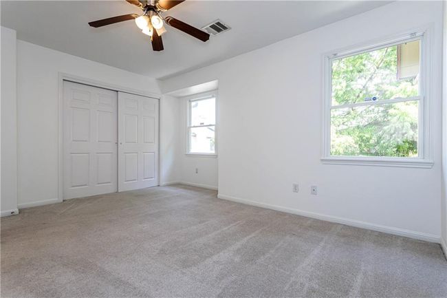 Unfurnished bedroom with light carpet, a closet, and ceiling fan | Image 14