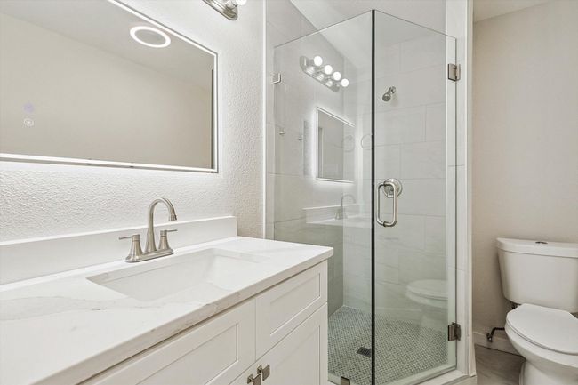Full bathroom with toilet, a shower stall, and vanity | Image 26