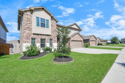 This beautiful home features 5 bedrooms, 3 full and 1 half baths, and a 3 car garage. | Image 2