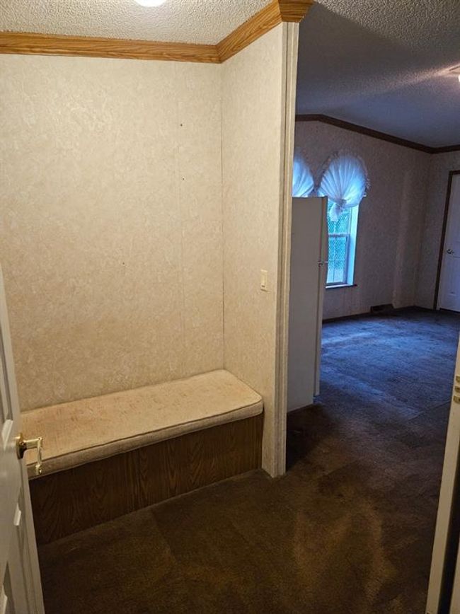 Bathroom with a textured ceiling and crown molding | Image 29