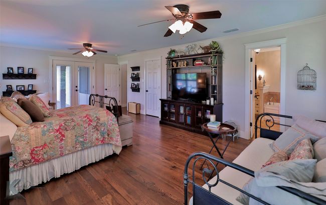 Bedroom featuring crown molding, wood floors, and a ceiling fan | Image 25