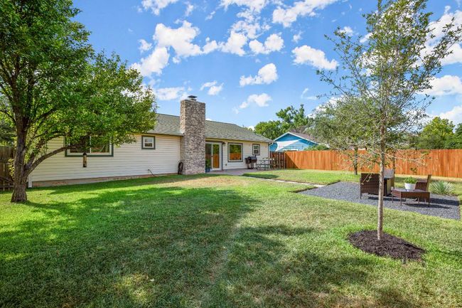 Back of house featuring a patio area, a chimney, and a shingled roof | Image 25