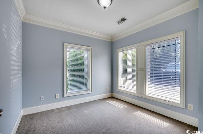 Carpeted empty room featuring crown molding and baseboards | Image 9