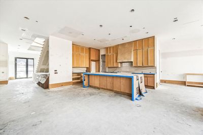 [Entry/Dining/kitchen/Bar] Exudes boldness while maintaining an inviting atmosphere. Kitchen island with waterfall. SubZero/Wolf appliances. Complete with a dedicated space for a coffee and wine bar, it's reminiscent of a high-end hotel - feels indulgent and welcoming. | Image 3