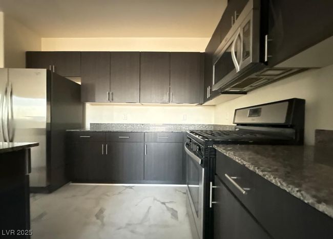 Kitchen with marble finish floor and stainless steel appliances | Image 6