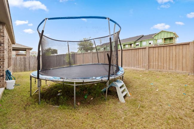 Fenced backyard with a trampoline | Image 31