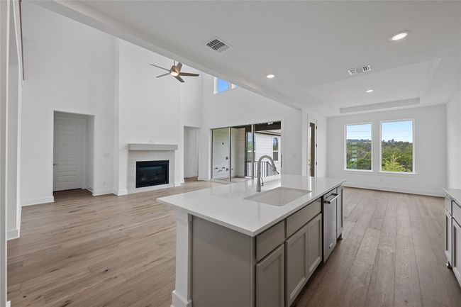 Kitchen featuring a sink, gray cabinets, open floor plan, ceiling fan, and recessed lighting | Image 8