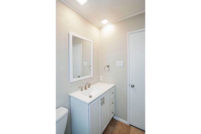 Bathroom with ornamental molding, tile floors, vanity, and toilet | Image 16
