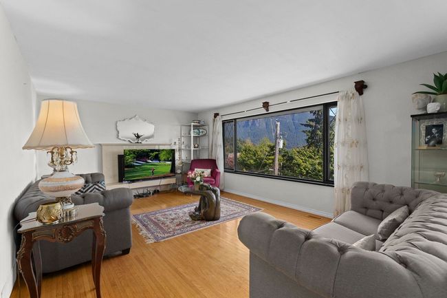 Living area with visible vents and wood finished floors | Image 4