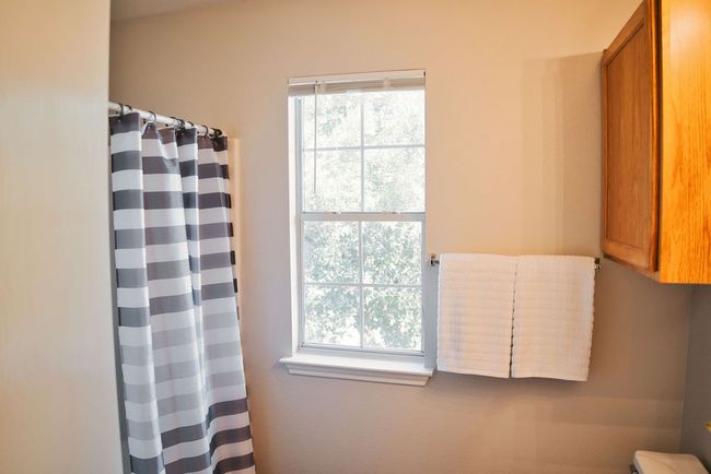 Bathroom featuring a shower with curtain | Image 28