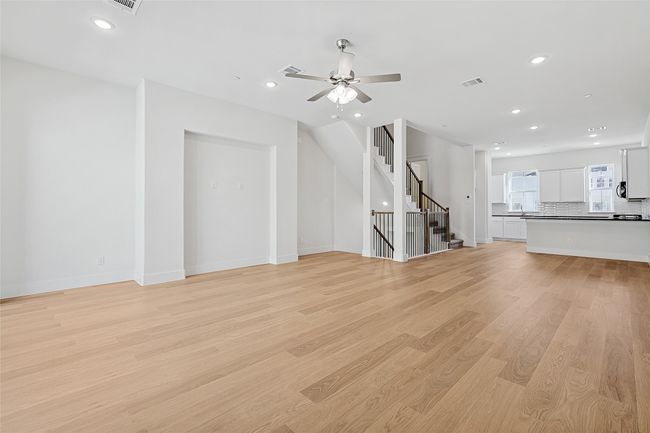 Unfurnished living room featuring ceiling fan and light wood-type flooring | Image 16