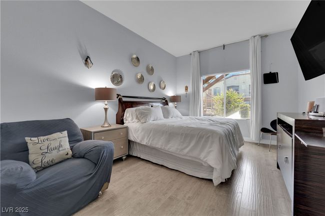 Bedroom featuring light wood-type flooring and lofted ceiling | Image 27