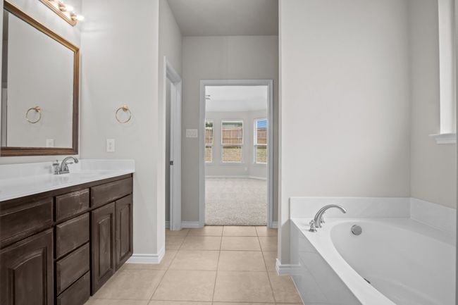 Full bath with a garden tub, baseboards, tile patterned floors, and vanity | Image 23
