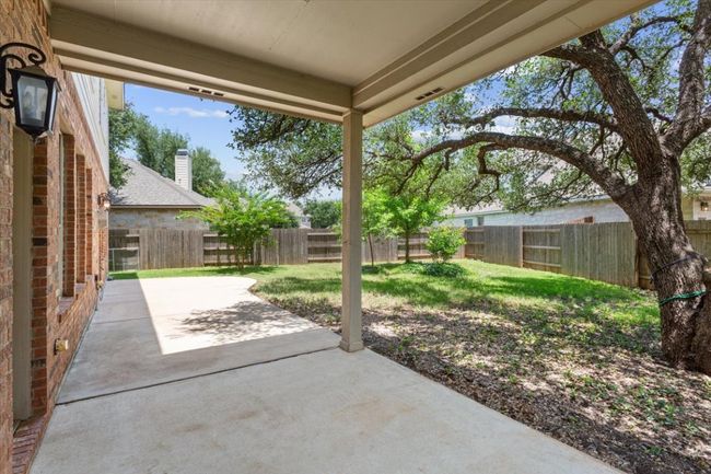 Fenced backyard with a patio | Image 36