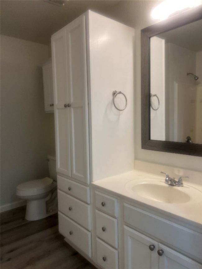 Full bath featuring vanity, wood finished floors, and a shower | Image 10