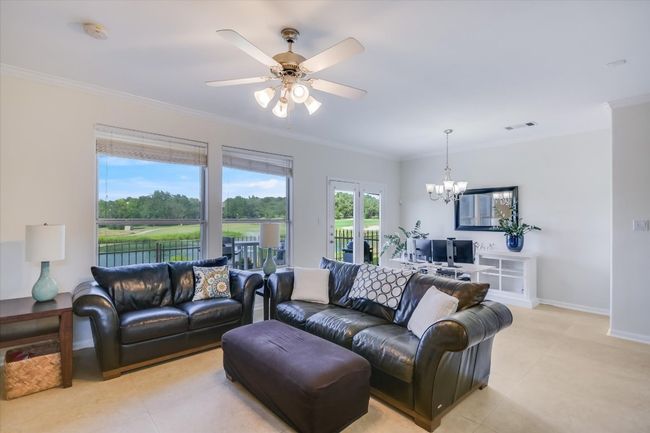 Living area featuring a chandelier, crown molding, light tile patterned floors, and ceiling fan | Image 5