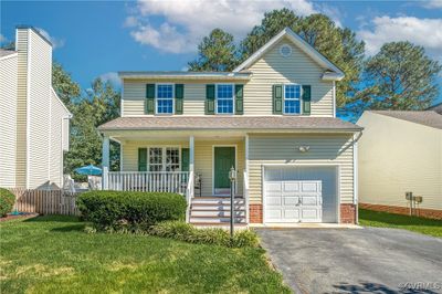 Front of property view featuring covered porch and garage | Image 1