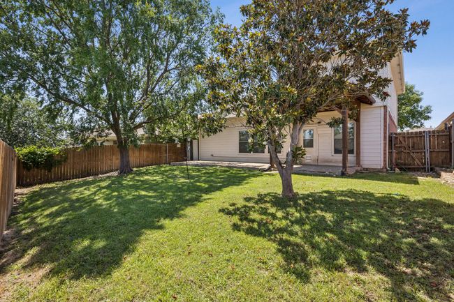 Fenced backyard with a full lenght patio | Image 25