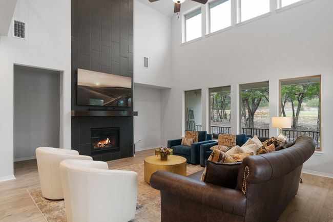 Vinyl plank flooring, a ceiling fan, and peaceful backyard views. | Image 8