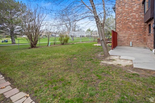 View of yard featuring a patio area and fence | Image 38