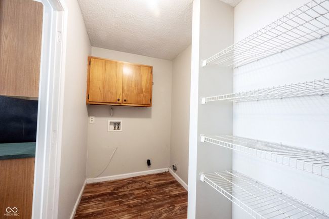 laundry room with dark wood finished floors, laundry area, hookup for a washing machine, baseboards, and a textured ceiling | Image 20