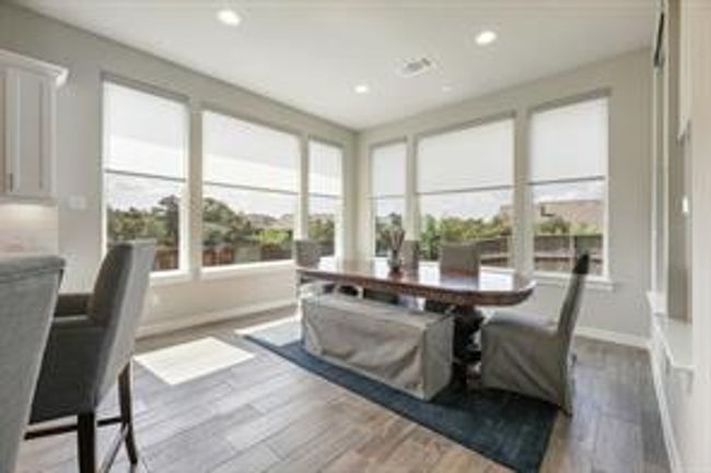 Dining space with wood finished floors and recessed lighting | Image 7