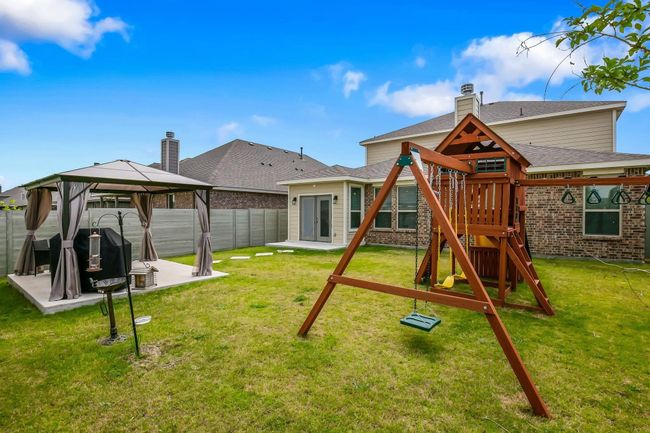 Back of house with a playground, a gazebo, a patio area, and brick siding | Image 25