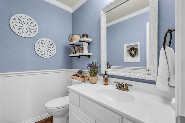 Bathroom featuring crown molding, toilet, and vanity | Image 17