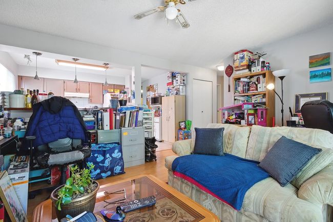 Living room featuring a ceiling fan and wood finished floors | Image 8