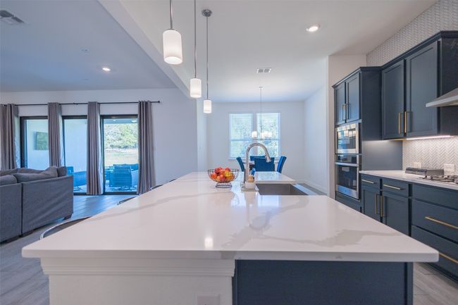 The long breakfast bar helps ensure that friends and family will always have space for enjoying a meal or beverage. | Image 14