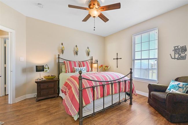 Spacious main-floor bedroom with a queen bed and generous closet. | Image 14