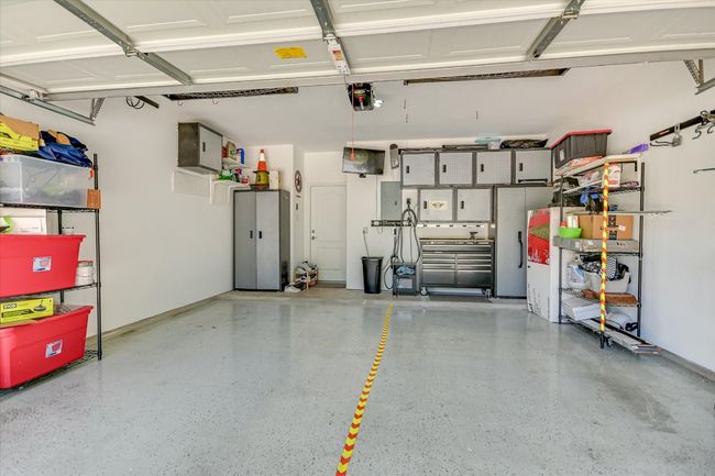 Two car garage with steel utility cabinets and 220 volt connection for electric vehicles | Image 30