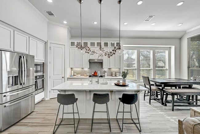 The crisp white cabinetry and modern finishes in the kitchen provide a sleek and stylish look, making it a culinary dream. | Image 7