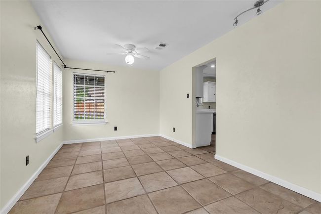 This view of the dining area shows the open doorway leading directly into the kitchen, making mealtime convenient and connected | Image 11