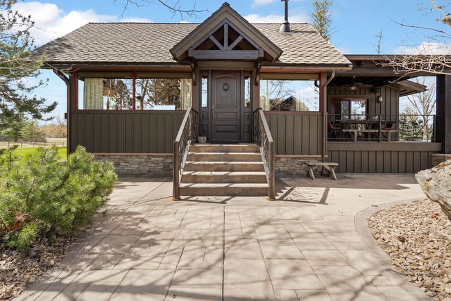 View of North Facing side of house with deck and French Doors going to Primary Suite. | Image 9