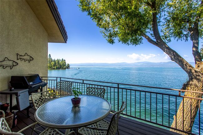Balcony with a water and mountain view and area for grilling | Image 12