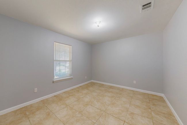 Empty room with visible vents and baseboards | Image 14
