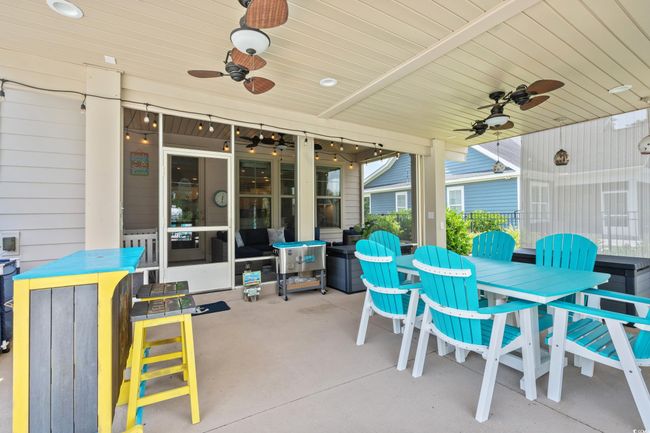 View of patio featuring a ceiling fan and outdoor dining space | Image 30