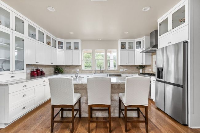 The well-appointed kitchen boasts ample counter space and stylish cabinetry for the home chef. | Image 11