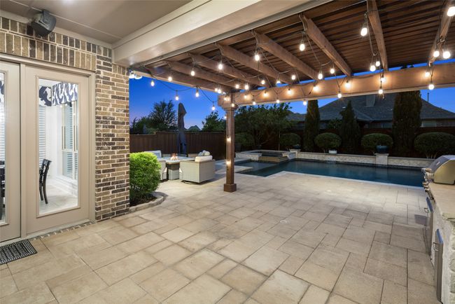 Covered patio features extended pergola, built in kitchen, wired for sound and ample entertaining spaces. | Image 34