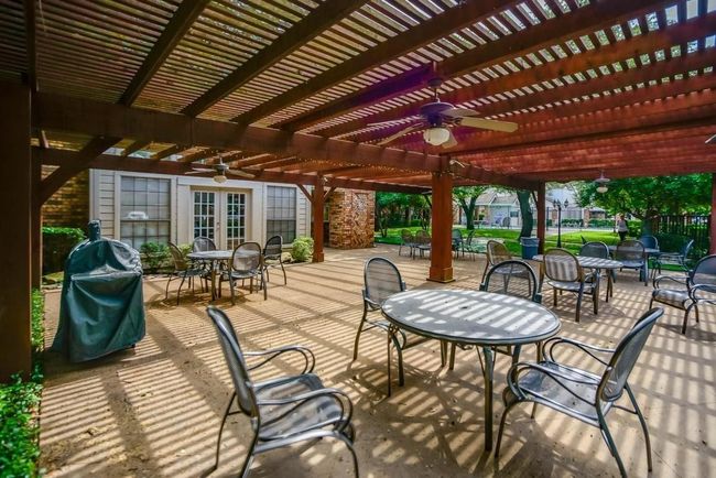 View of patio featuring a ceiling fan, a pergola, outdoor dining area, french doors, and a grill | Image 26