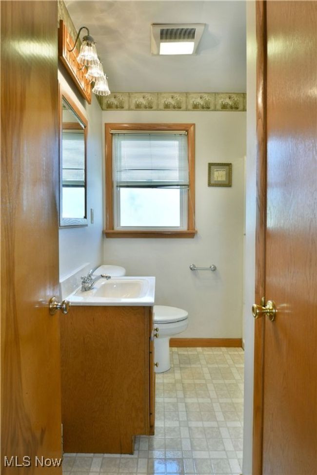 Bathroom featuring baseboards, visible vents, toilet, and vanity | Image 30