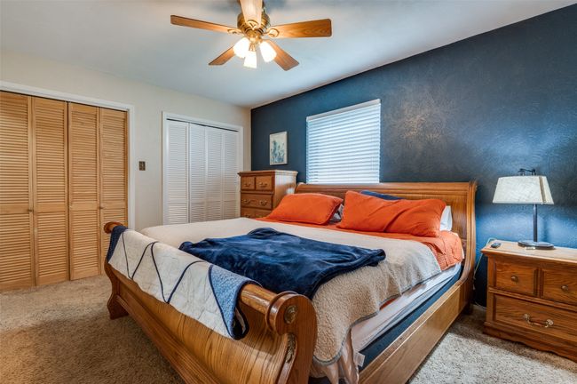 Bedroom with carpet floors, a ceiling fan, and two closets | Image 16