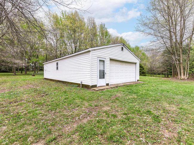 24 x 30 storage barn separated into 2 rooms. Front room with concrete floor, back room with wood floor. Electrical service to the barn with no water. Perfect for storage of toys, man cave or home office. | Image 48